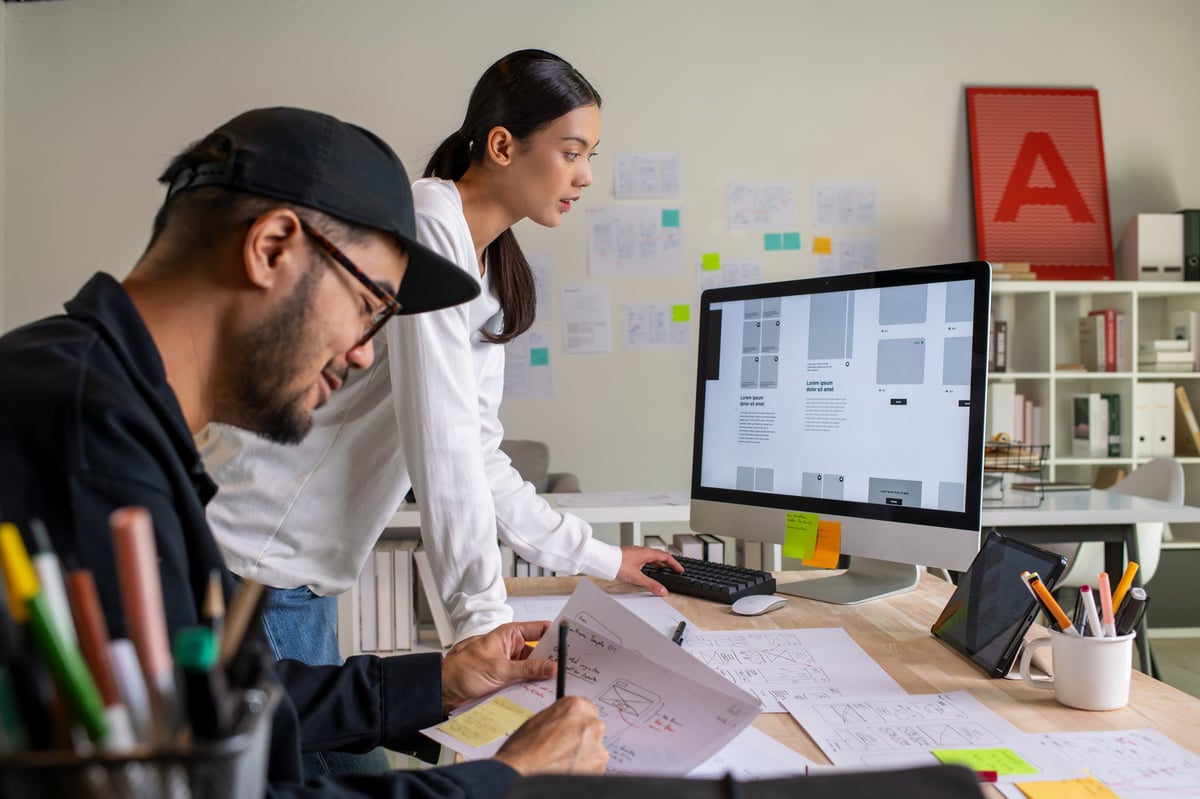 UX UI designers discussing and brainstorming wireframes
